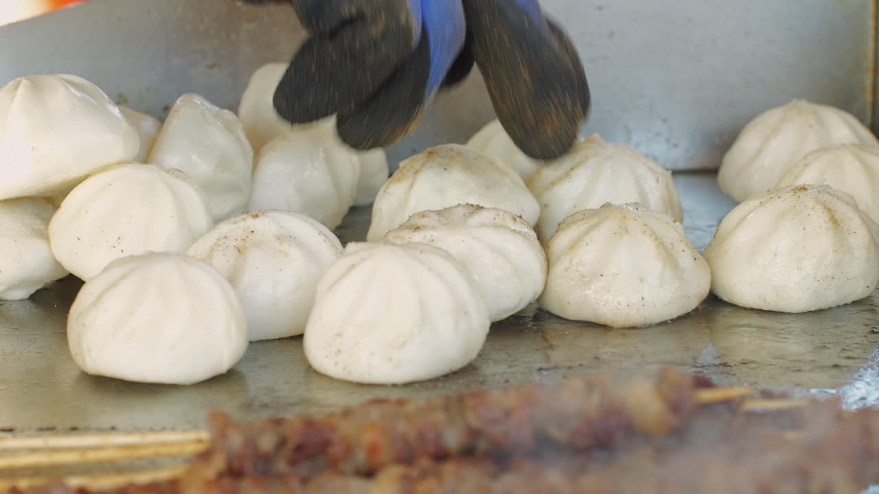 Cooking asian baozi with meat on desk close -up. Steaming Technique.. Street food Chinese and Korean pyanse, fast street food local festival
