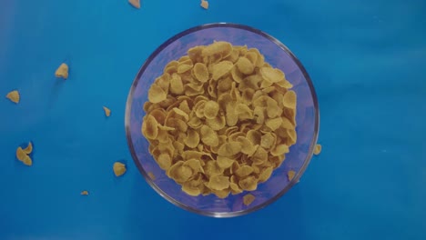 Pouring-cereal-flakes-and-milk-into-a-glass-in-slow-motion