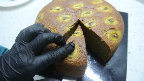 freshly baked cakes are carefully cut to get the same cut size. it is cut using a long cutting knife.