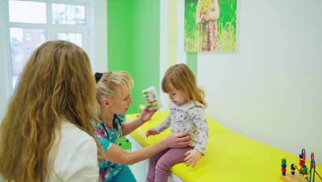 doctor examining little girl. female doctor examining kid little child girl