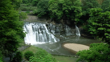 a waterfall cascades in a tropical rainforest with rock