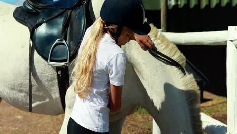 Girl-touching-the-white-horse-in-the-ranch-4k