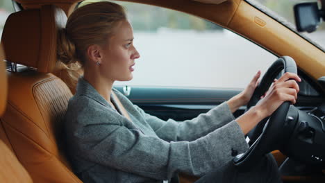 angry businesswoman punching steering wheel