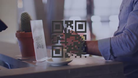 Animation of qr code over biracial businessman using smartphone