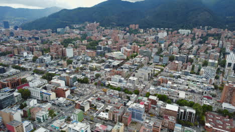 Cinematic-Establishing-Shot-Of-Large-Urban-City-Area-During-Daylight-With-Mountain-Background