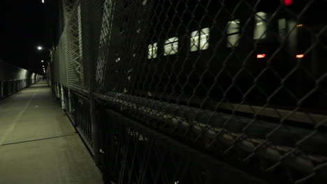 this is a shot of the nyc subway taken from the walking path on the manhattan bridge