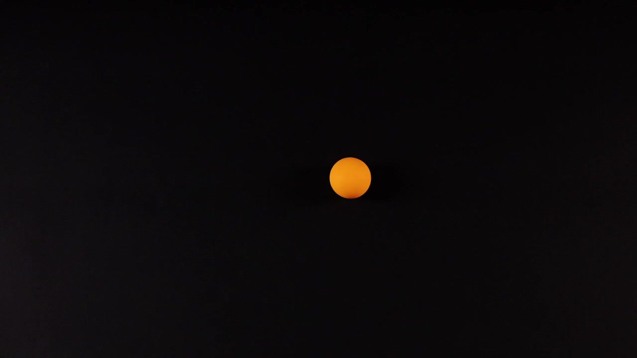 Orange ball moves across a dark background