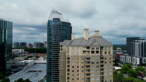 Aerial-descending-footage-of-tall-buildings-in-modern-urban-borough