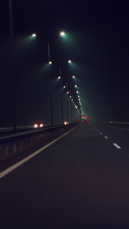 car is driving quickly along the highway in the dark. night travel by car. movement speed vertical video