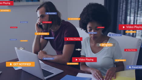 Notifications-and-video-playing-animation-over-people-working-at-desk