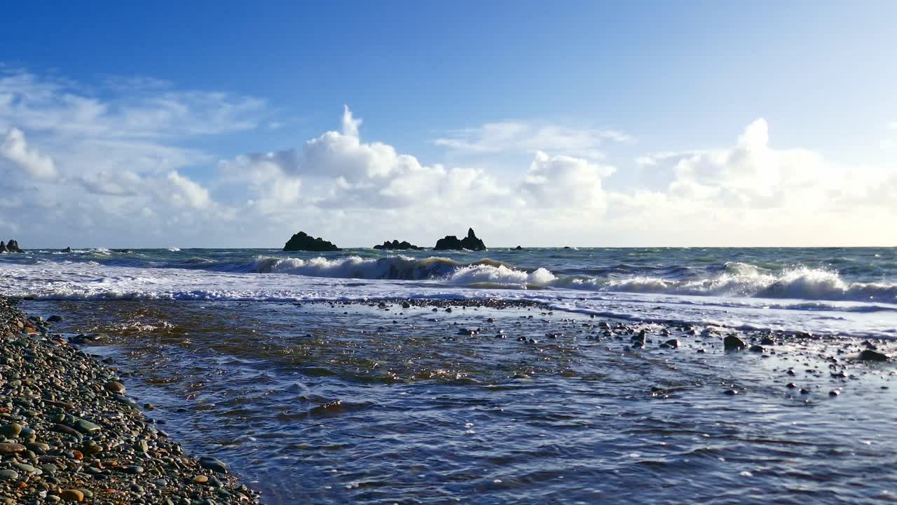 Epic Ireland river running to sea magic sea stacks and waves in beginning of storm Copper Coast Waterford