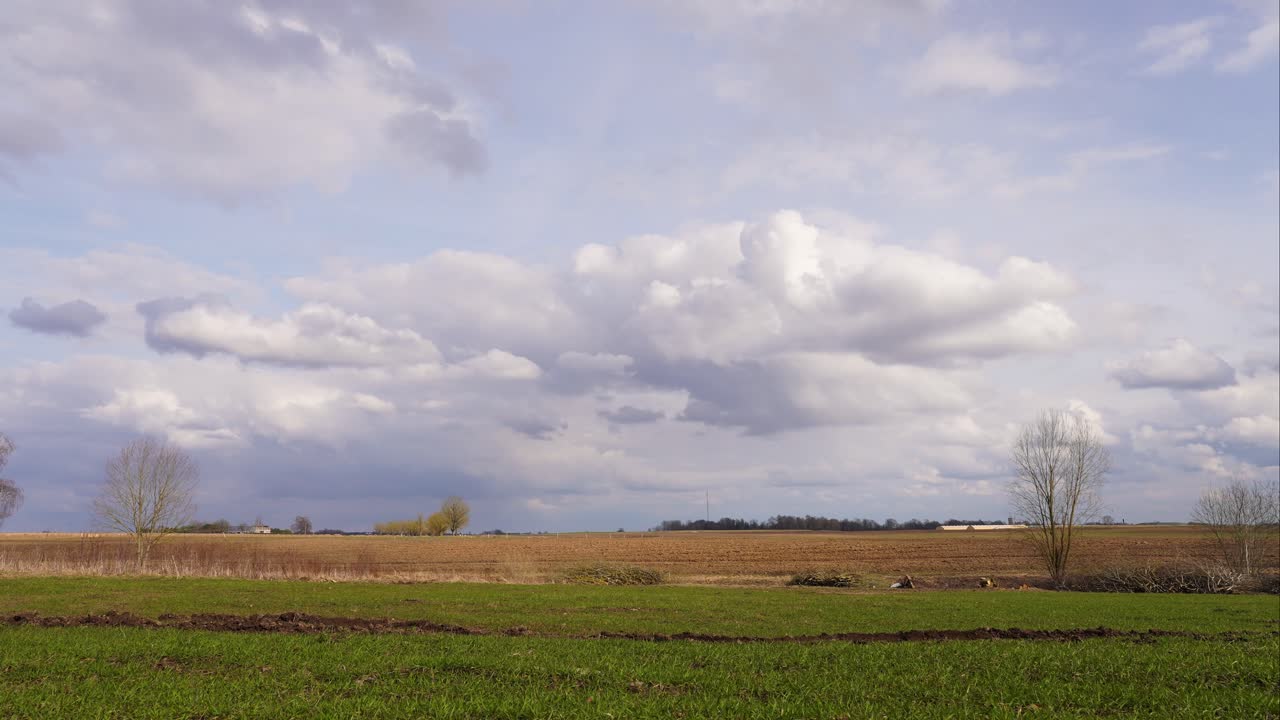 Fast moving cloud timelapse over Latvian agricultural field landscape