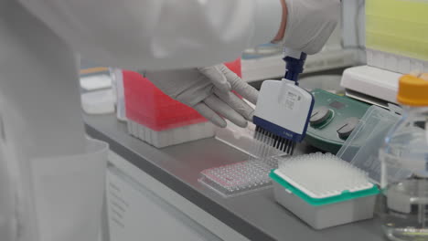 Close-up-shot-of-gloved-scientist-hand-manipulating-lab-tools