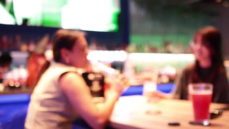 two women sharing drinks and conversation