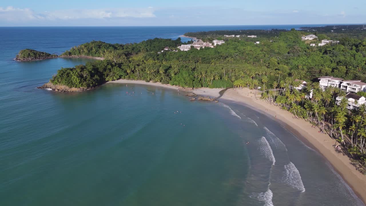 Aerial view of luxury villas and private sandy beach of Bonita. Bay with clear water at sunset time.Wide shot. Tropical island of Dominican Republic.