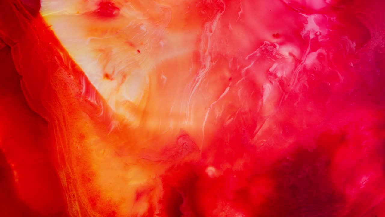 Fiery macro of colorful alcoholic ink swirling in liquid, abstract and emotional art