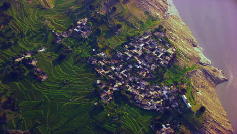 A-helicopter-view-over-the-beautiful-and-majestic-valley-with-river-corner,-green-farms-and-beautiful-sunshine-on-water