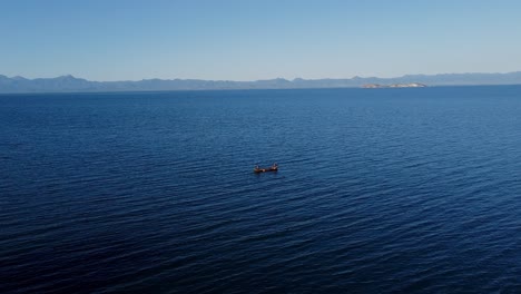 Fisherman-on-boat-sailing-Caribbean-Sea,-in-Cap-Haitien,-HAITI