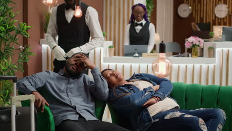 couple sleeping at hotel reception