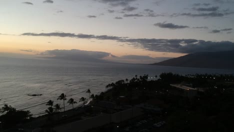 AERIAL-DRONE-FOOTAGE-OF-THE-SURF-OFF-THE-COAST-IN-KIHEI-MAUI-HAWAII-TRAVELING-NORTH-TOWARD-KALAMA-SKATE-PARK-DURING-SUNSET-IN-1080