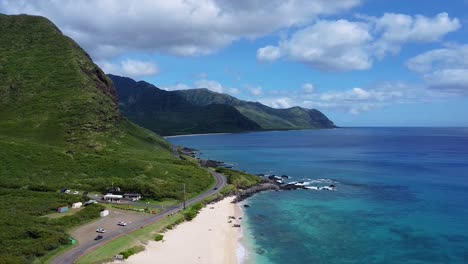 drone video of cars driving in hawaii next to the ocean