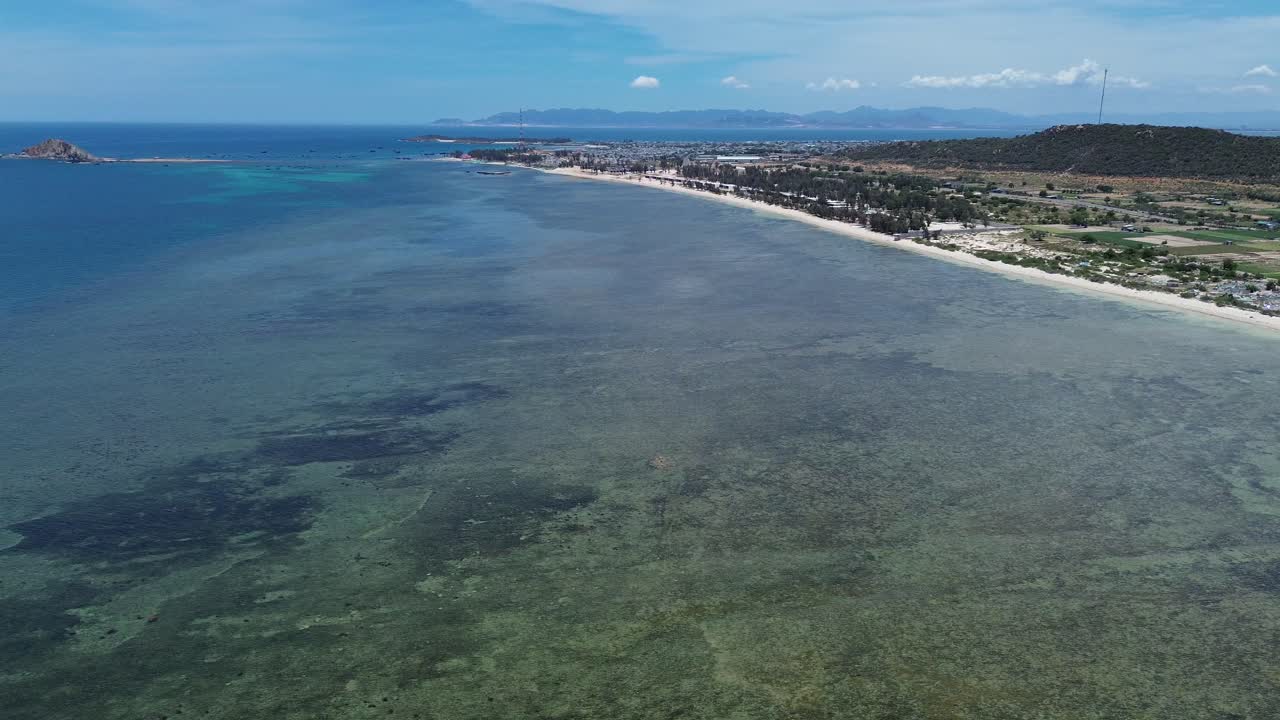 Aerial view of My Hoa Lagoon in Phan Rang, Vietnam, captured with an elegant and steady pan left movement showcasing the coastline. My Hoa Vietnam, famous kitesurfing spot during low season.