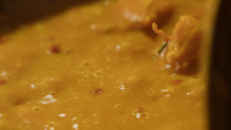 yellow boiling sauce on pan close-up. asian cuisine concept. curry is a dish with a sauce seasoned with spices. curries may contain fish, meat, poultry, or shellfish, either alone or in combination with vegetables. others are vegetarian.