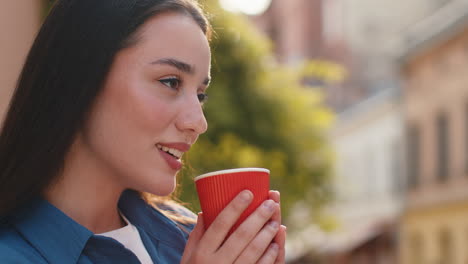 pretty woman enjoying drinking morning aroma coffee hot drink relaxing taking a break in city street