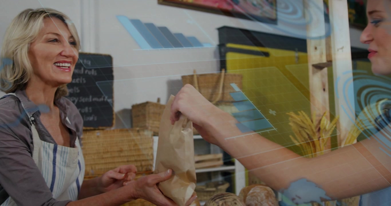 Commesso di panetteria che consegna un sacchetto di carta a un cliente nel negozio.