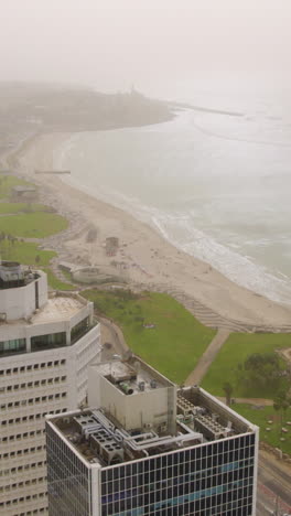 The coastline of Tel Aviv and Jaffa during a sandstorm covered the entire city (2024) - dust in the air, poor visibility and heavy air pollution - push in shot - Vertical video