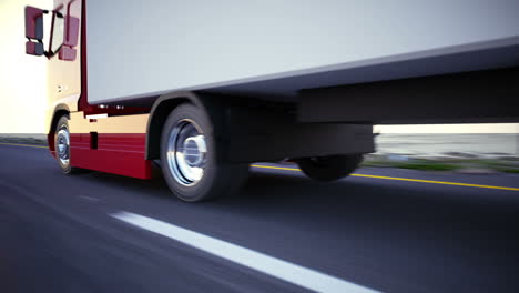 animation of a truck on the road with sunset at the skyline. a large delivery truck is moving towards setting sun. cargo delivery. lorry with a huge capacity trailer. side view. loopable. hd