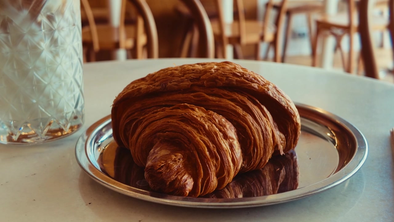 Fresh Croissant Served on a Metal Plate in a Cafe