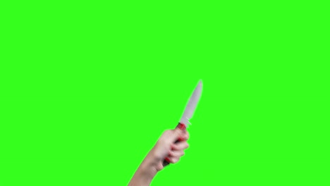 video de una mano femenina con un cuchillo en fondo verde