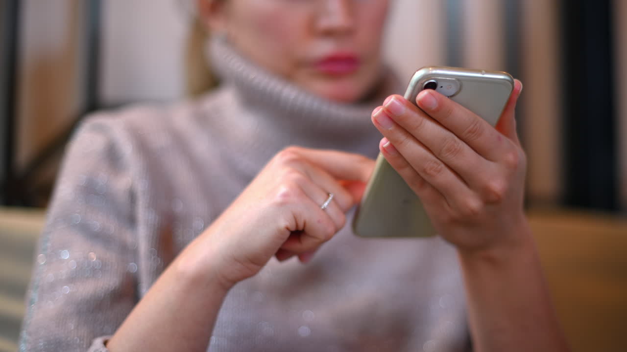 Woman working on mobile phone at a restaurant