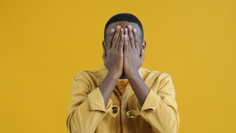 man expressing surprise and covering face