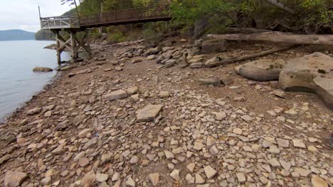 FPV-through-bridge-on-beach-in-Autumn