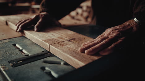 a slow motion of a carpenter cutting wood with a special machine