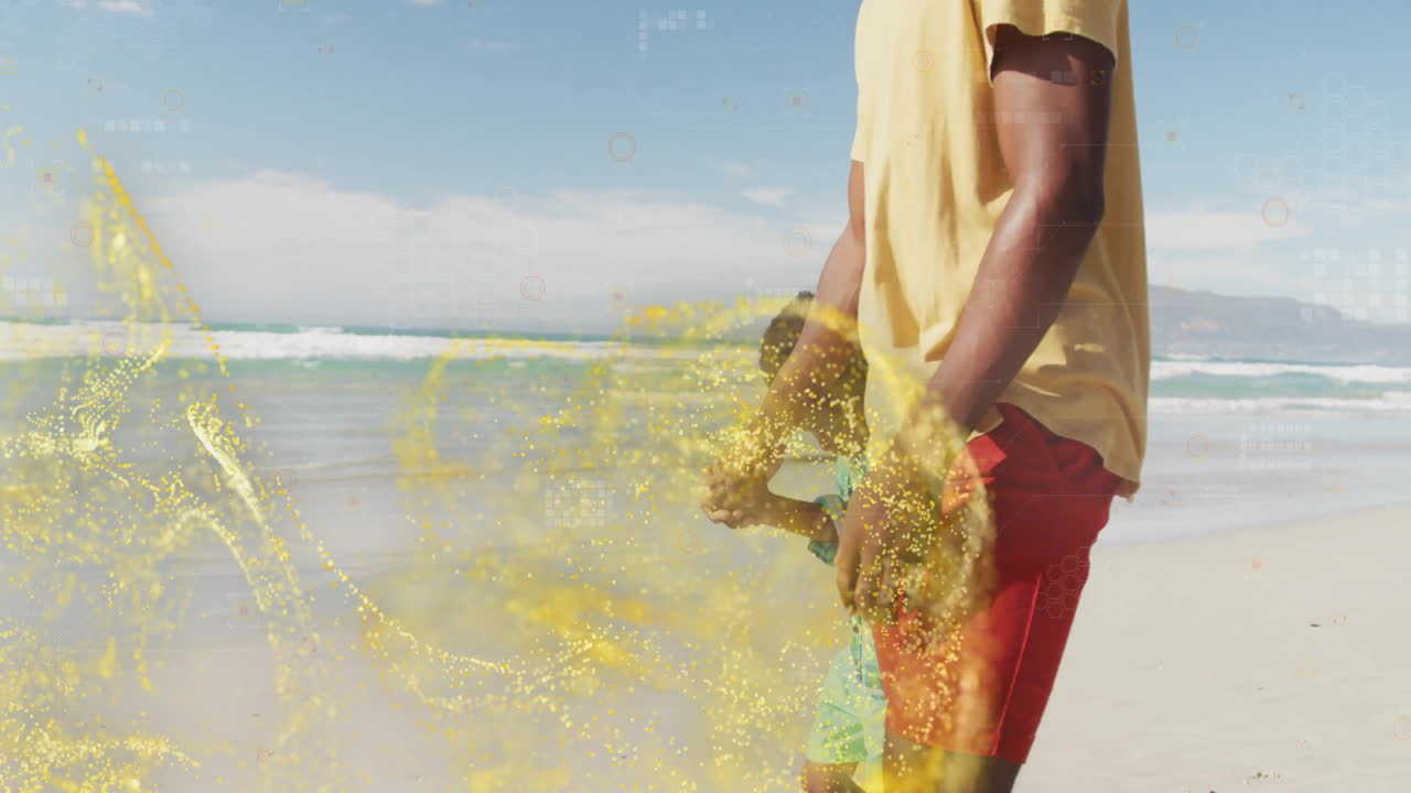 Walking on beach, man in yellow shirt surrounded by animation of sparkles