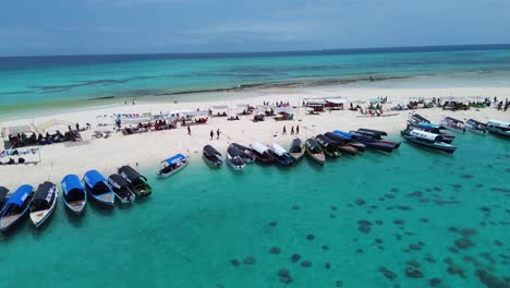 beautiful tropical island beach with boats and clear turquoise water