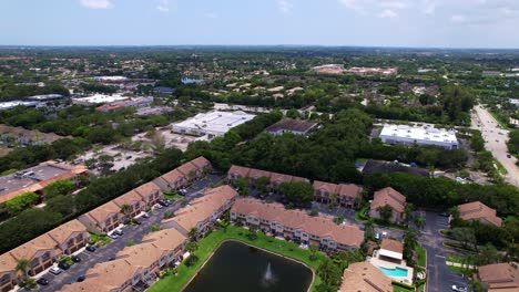 drone footage over residential area with green lawns and rows of houses