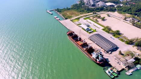 aerial drone top view of containers cargo ship at industrial import-export port. business logistic import and export freight transportation by container ship in open sea