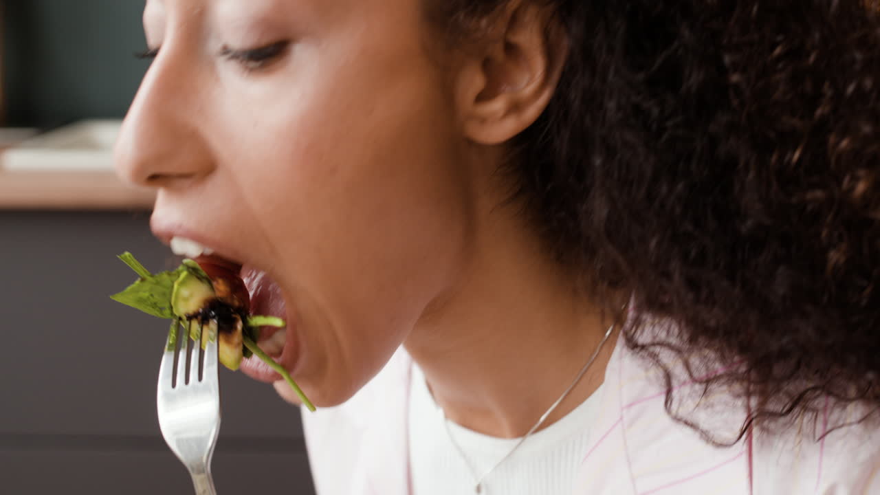 Close-up of a person eating a healthy salad with a fork