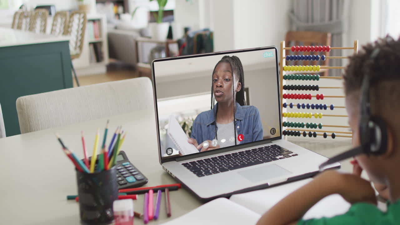 Biracial boy on laptop online learning with african american schoolgirl