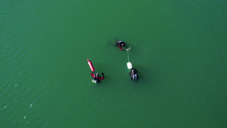 aerial shot overhead 3 divers out conducting training in lac du crès, france