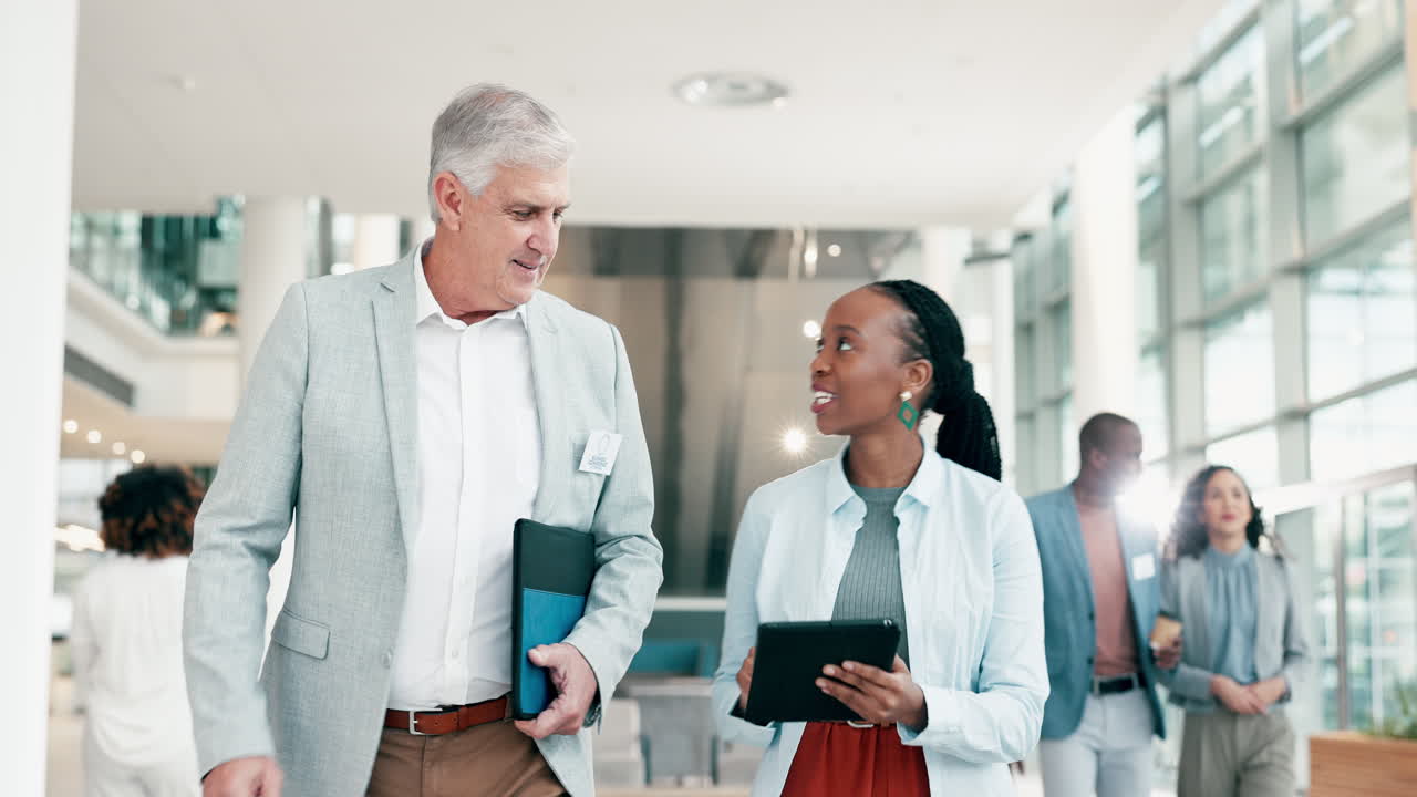 Tablet, talking and walking business people