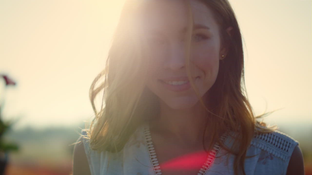 밖의 태양 반사 조명에서 부드럽게 미소 짓는 예쁜 소녀의 초상화