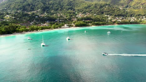 mahe seychelles, boat approaching shore at beau vallon after a half day excursion