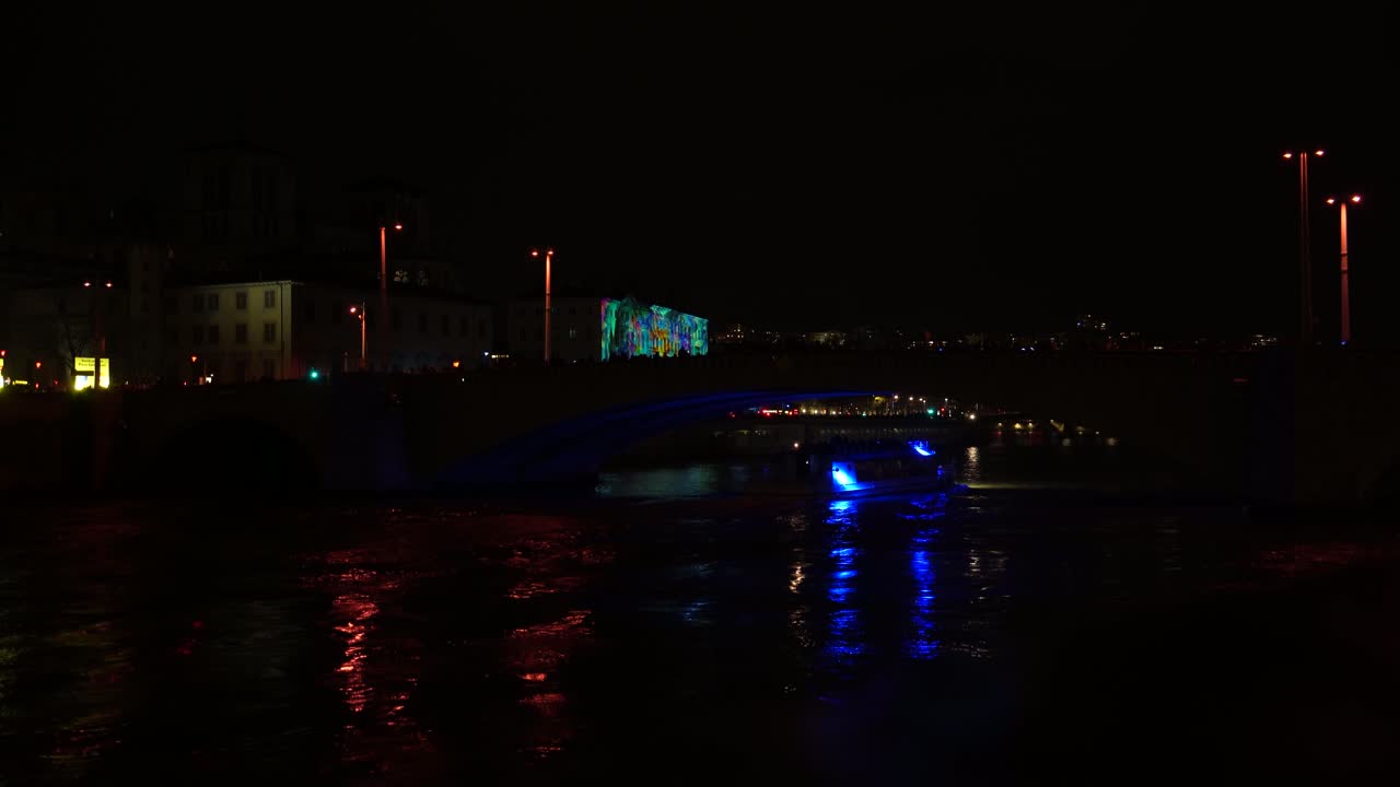 Beautiful quiet Lyon city center at night: Illuminated buildings, bridges, and lights reflecting on Rhone river