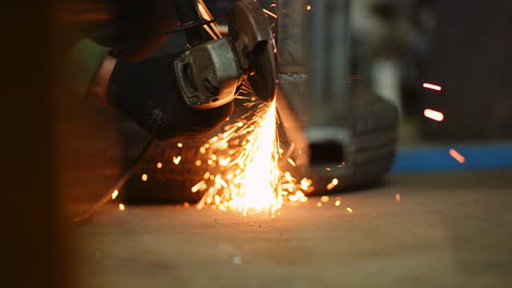 industry worker grinding metal with angle grinder 10