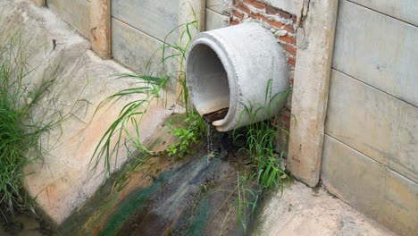 industrial sewage water draining out from cement tube.